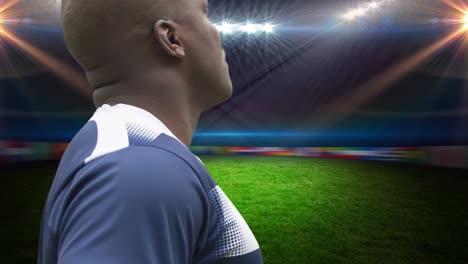 animation of african american male rugby player holding ball over stadium