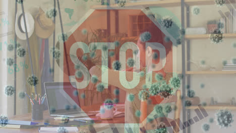 animation of virus cells and stop sign over biracial woman working from home