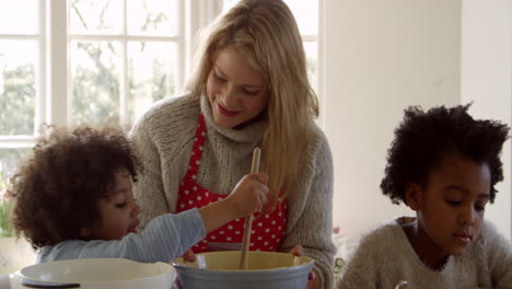 mother and children baking cake at home shot on r3d