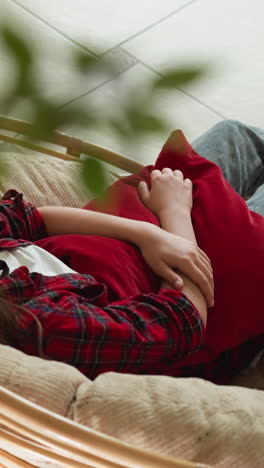 lady turns home in contemplative haven. cozy armchair silently bears witness to emotional storm of woman grieving heart. melancholic period of life