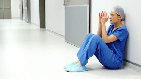 worried nurse sitting on the floor