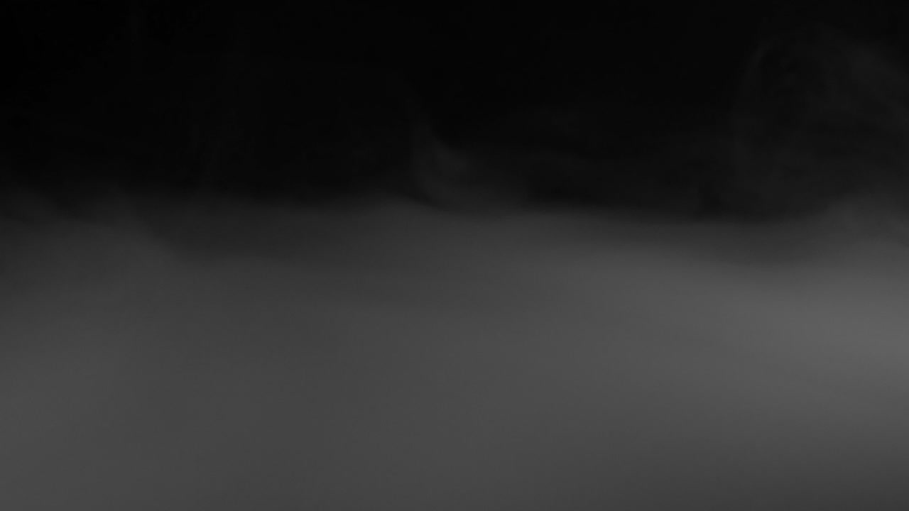 Thick White Smoke Spreading and Dissipating on Black Background