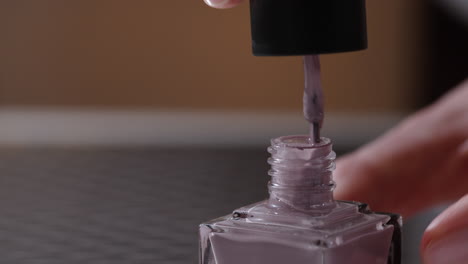 applying purple nail polish