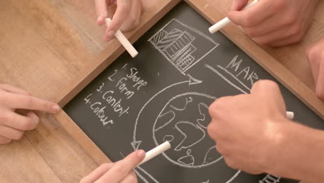 creative business team drawing on a blackboard