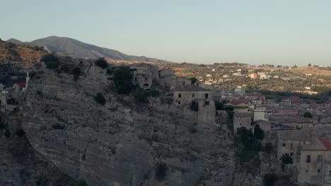 panning across a town built into the ancient calabrian cliffs of southern italy