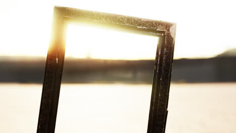 Empty-wooden-picture-frame-on-the-beach-sand