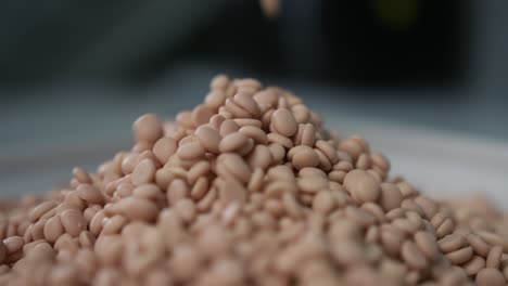 slow motion shot of granules for milling machine coolant falling down and creating a pile of granules