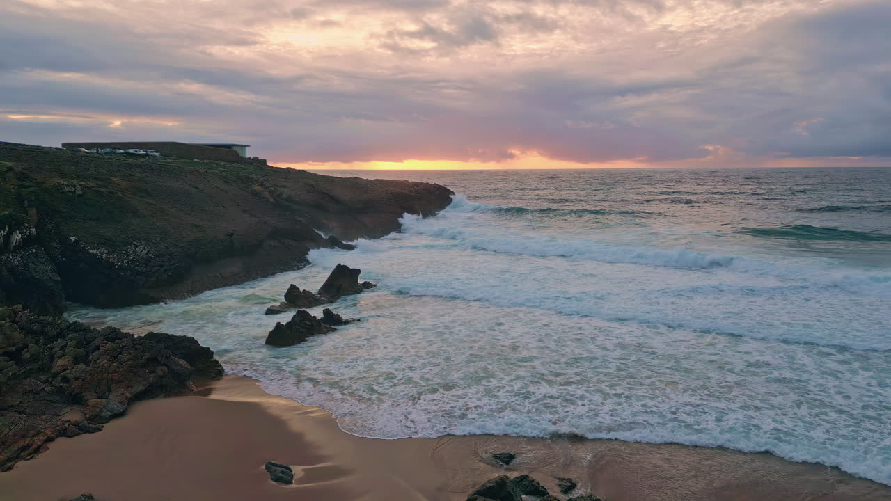 Sunset sky ocean waves crashing of coastal cliffside drone shot. sea