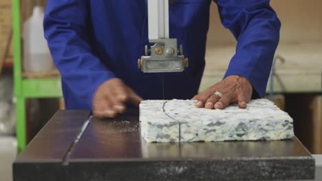 worker cutting a piece of concrete block