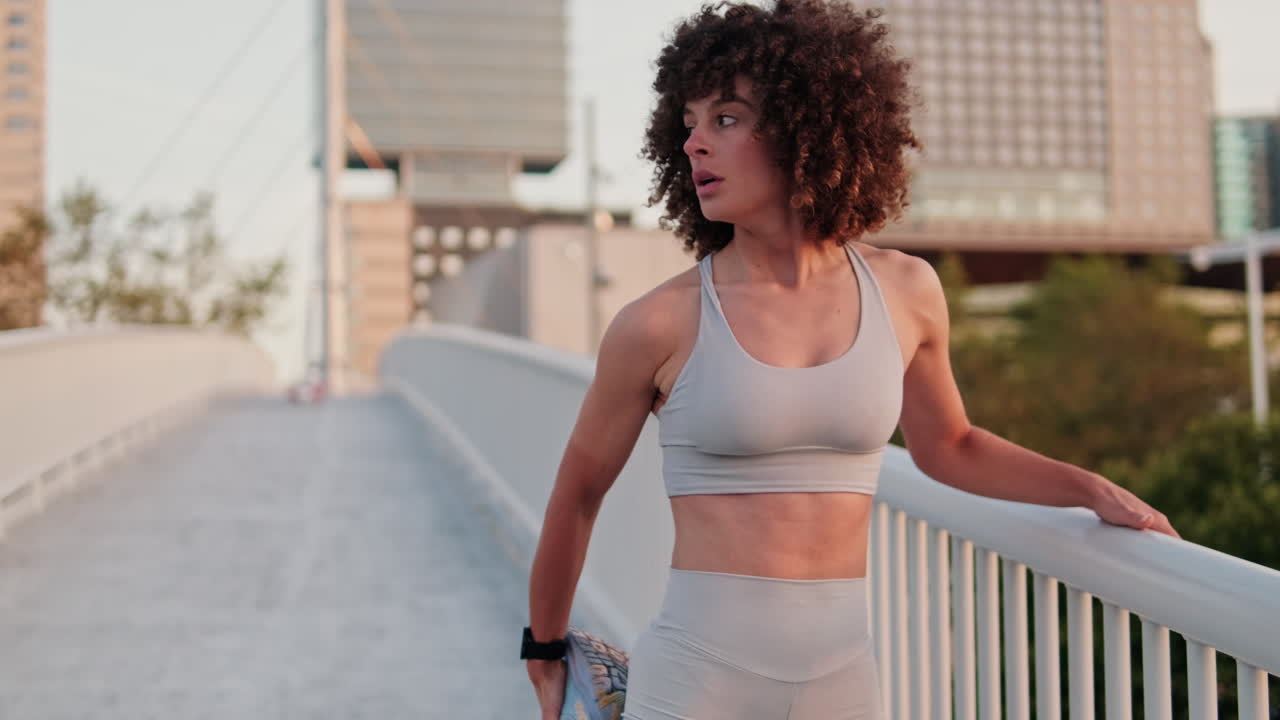 Sporty Woman Stretches on City Bridge