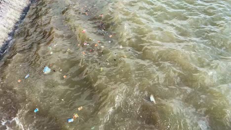 Basura-Y-Basura-En-Aguas-Turbias-Contaminadas-En-La-Costa-De-La-Playa---Importancia-Del-Reciclaje,-Protección-De-La-Vida-Marina-Ambiental