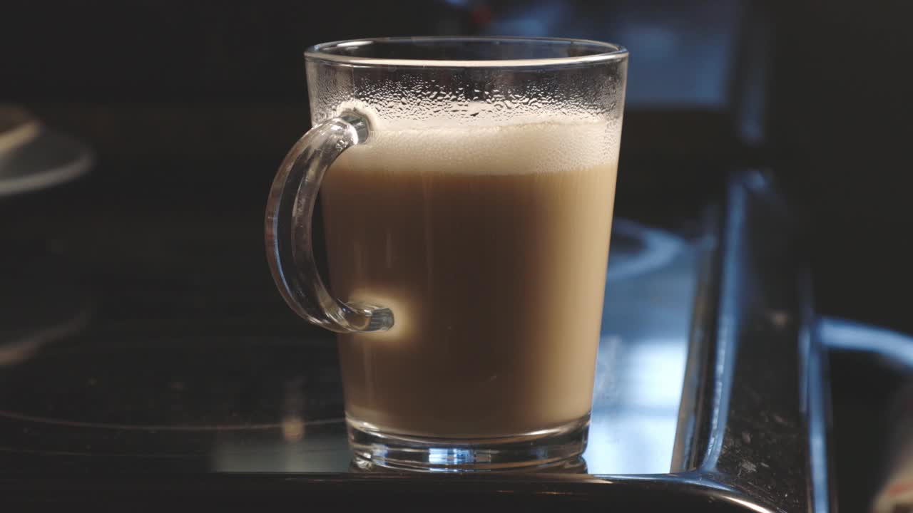 A Glass of Aromatic And Creamy Hot Coffee For Breakfast. - close up shot