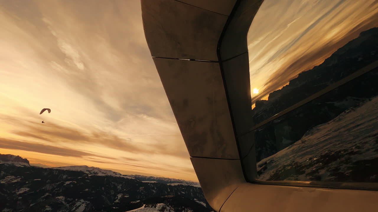 Sunset Paragliding View from Airplane Window over the Alps