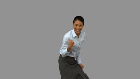 Pretty-businesswoman-gesturing-on-grey-screen