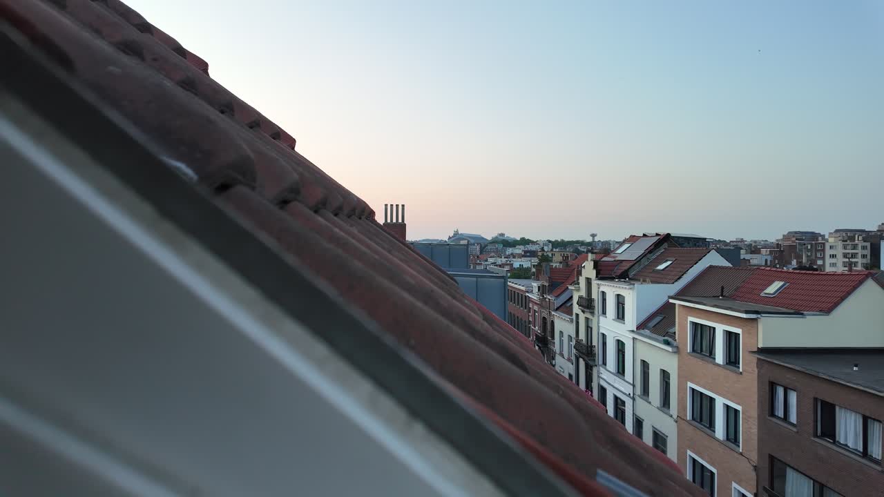 Camera pulls back over red rooftops in central Brussels