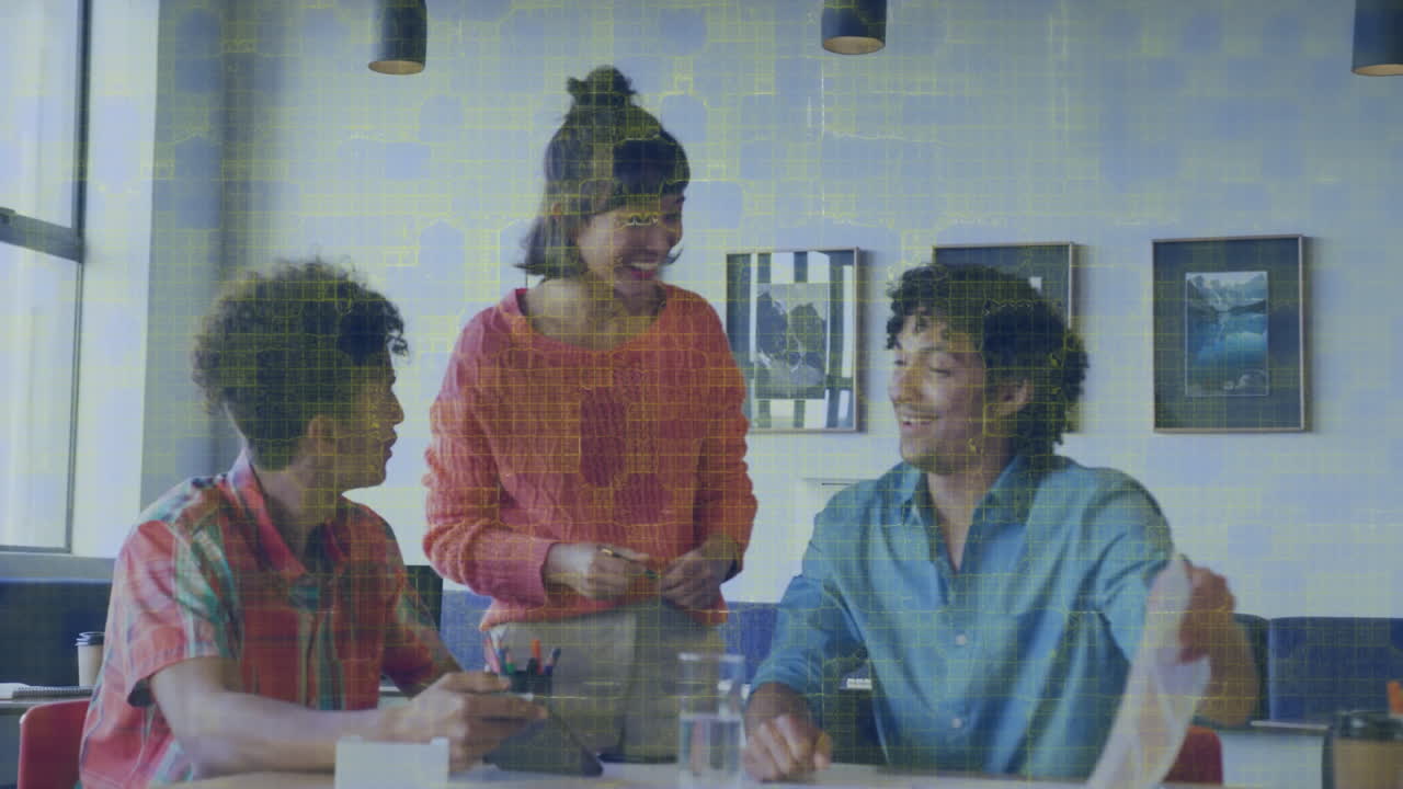 Three people collaborating at table with digital data processing animation overlay