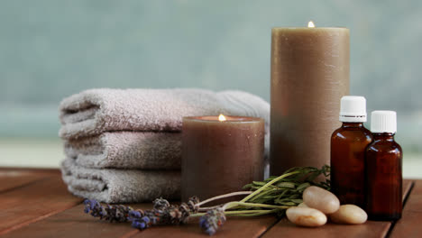 towels candles and dried lavender by the pool