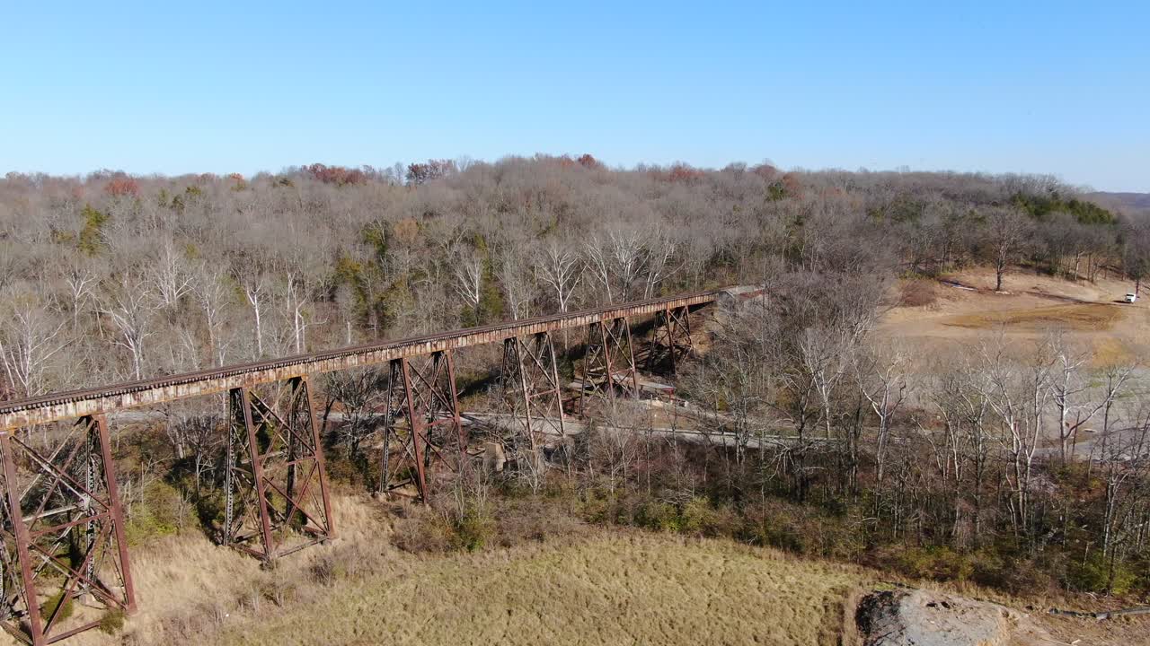 Aerial Shot Pushing Across a Field Towards the Pope Lick Railroad Trestle in Louisville Kentucky on a Sunny Afternoon