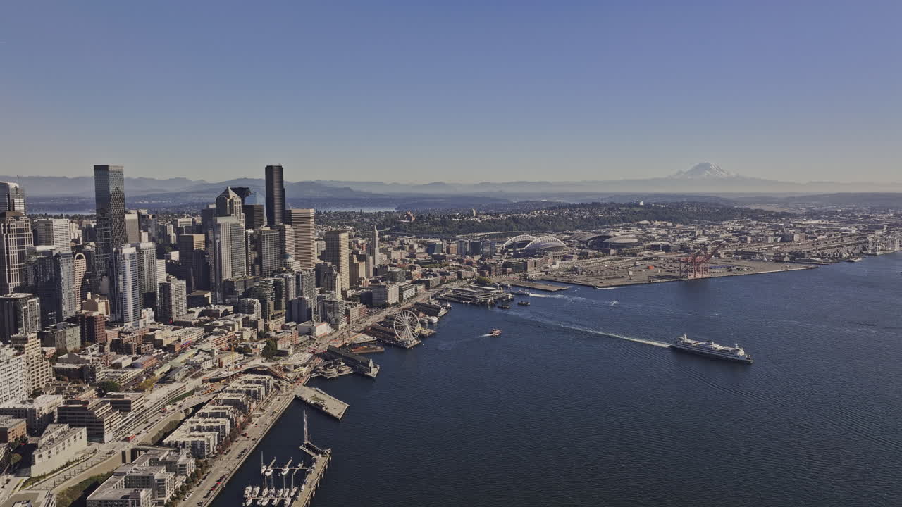 Seattle Washington Aerial v146 flyover Elliott bay capturing ferry departing waterfront terminal, downtown cityscape and distant mountains on a clear day - Shot with Mavic 3 Pro Cine - Oct 6th 2023
