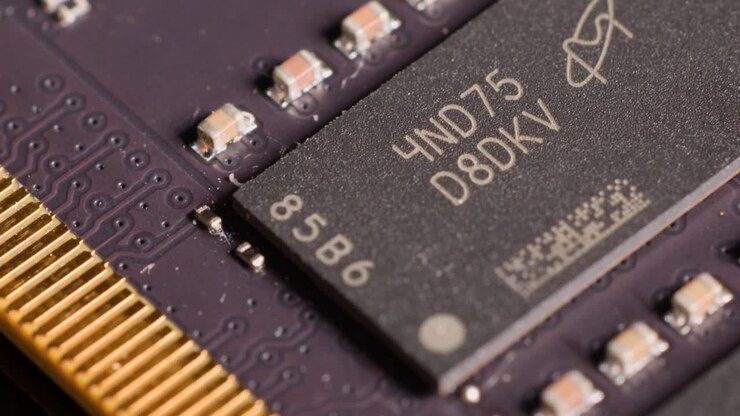 Extreme macro panning shot across a computer memory module revealing detailed electronic components and microchips