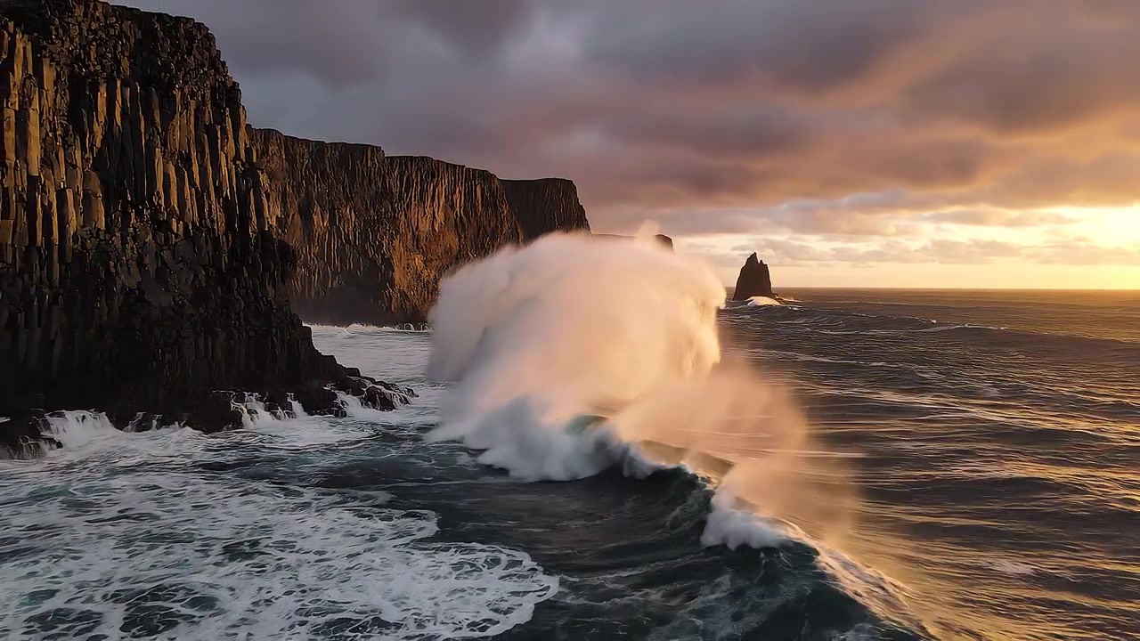 Dramatic Golden Sunset Over Ocean Waves and Basalt Cliffs