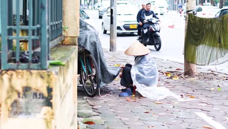 vendor sits by bicycle on busy street