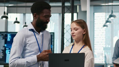 female engineer and coworker coding ai algorithms to debug software issues