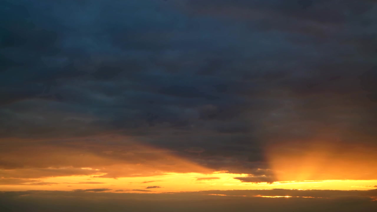 Dramatic Sunset Clouds Moving Over Golden Horizon