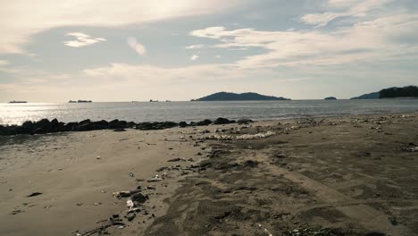 summer beautiful view of teluk likas beach, white sandy beach, small island, blue sea water and green trees,kota kinabalu,sabah,malaysia.