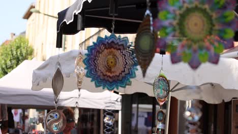 vibrant wind spinners displayed at a market stall