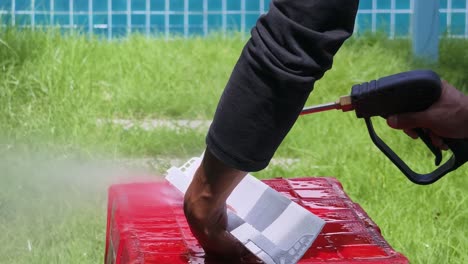 cleaning an air conditioning component with a pressure washer