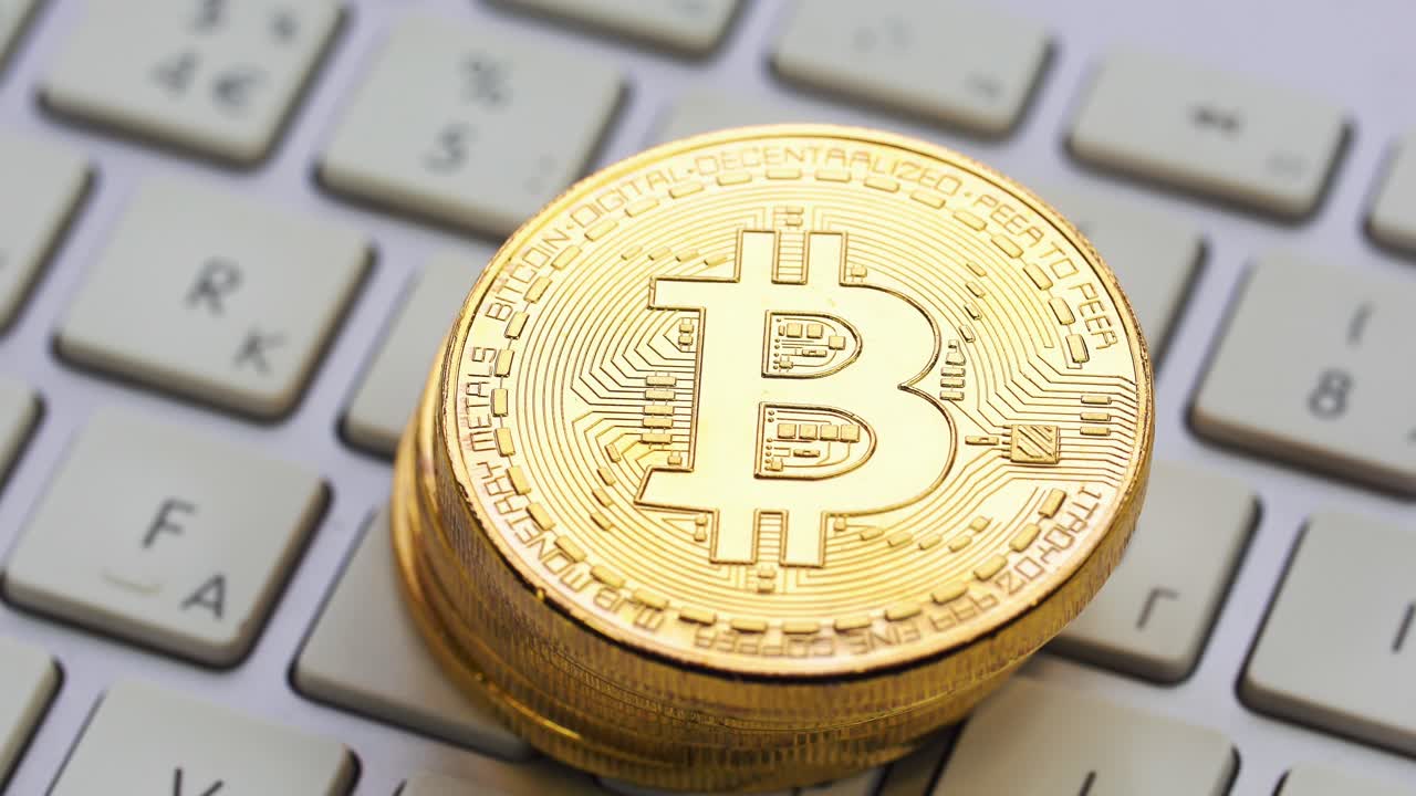 Stack of Bitcoin coins on a keyboard
