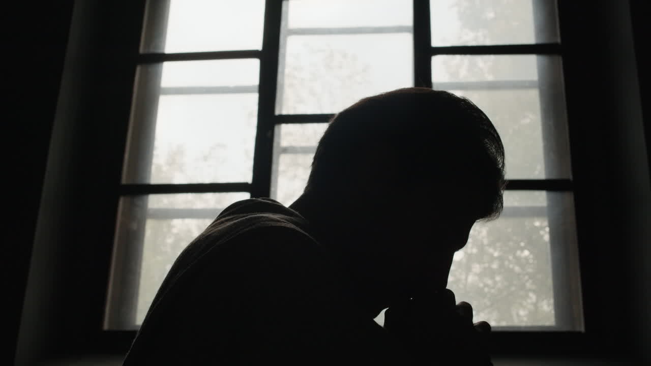 Silhouette of a Man by a Window