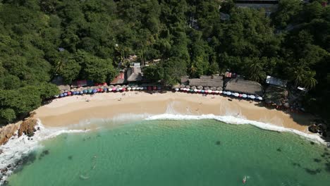 Aerial-Drone-Fly-Above-Turquoise-Bay-of-Carrizalillo-Beach-Puerto-Escondido-Sea-in-Mexico