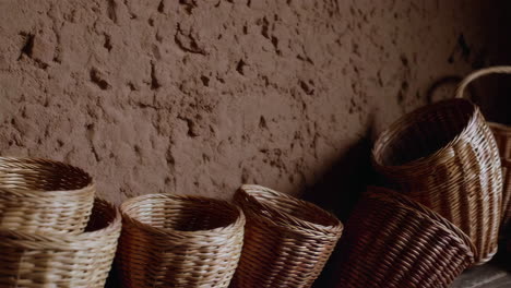 wicker baskets against an adobe wall