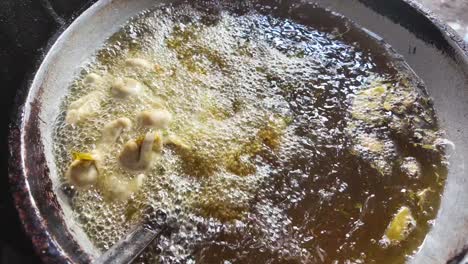 fried food being cooked in a pan