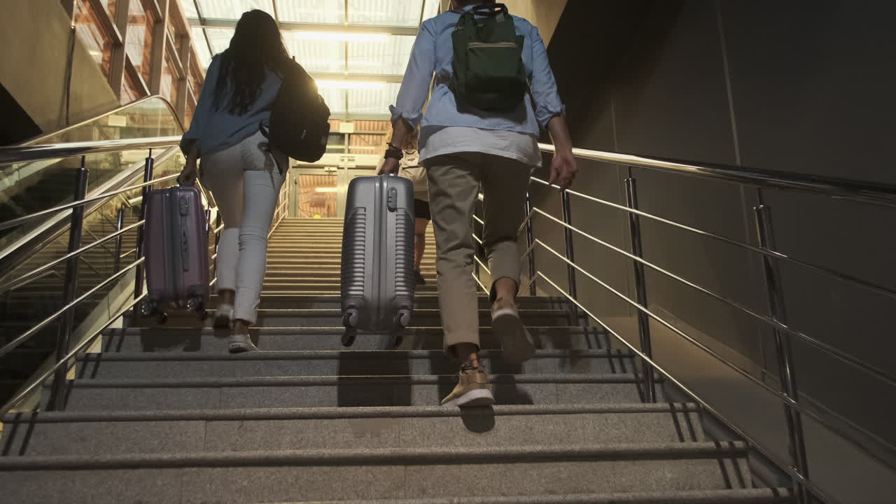 Travelers Climbing Stairs with Luggage at Night