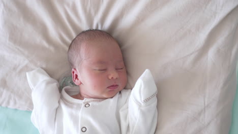 portrait of a beautiful newborn baby boy sleeping. adorable infant sleeping on soft blanket and smiling. infancy concept.