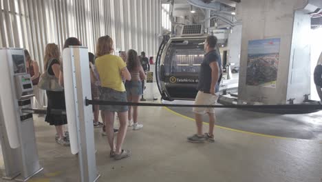 tourists wait in line for the porto cable car in vila nova de gaia, sunny day, modern station