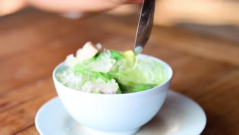 stirring and serving traditional thai lod chong dessert