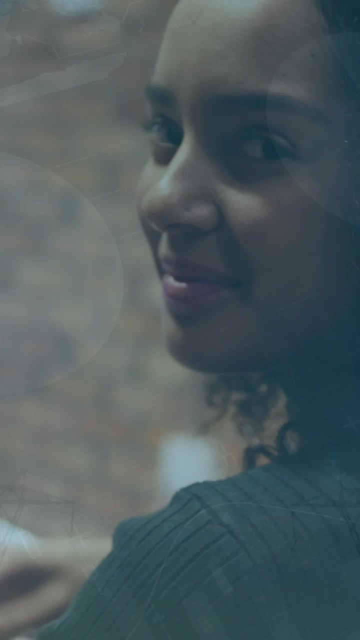 Young Woman Working on Laptop and Smiling with Digital Overlay