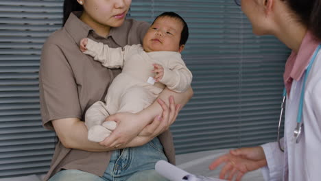 baby medical checkup with mother and doctor