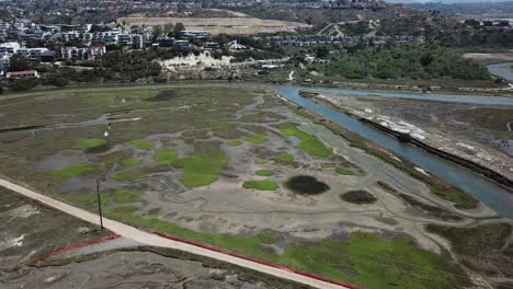 aerial view from a drone flying to a river near a neighborhood