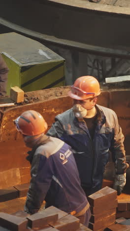 workers handling materials in a metal foundry