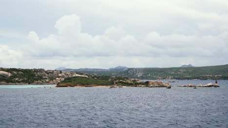 Serene-Sardinian-coastline-with-rocky-outcrops-and-calm-sea