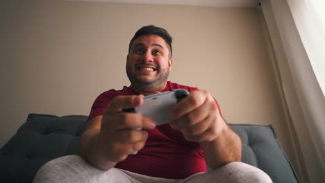 man excited playing video games celebrating achievment victory