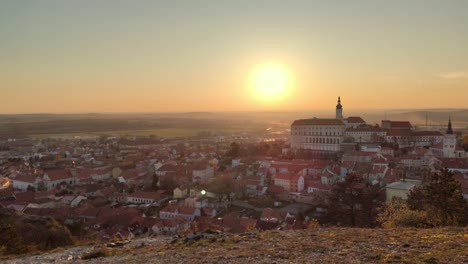 sunset over a medieval town with a castle