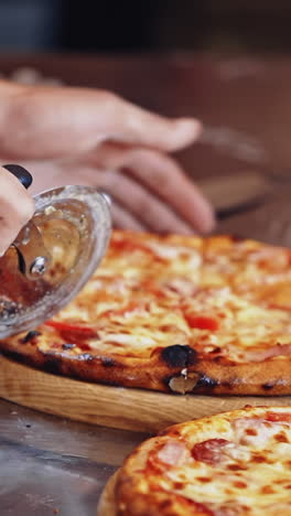 chef cutting pizza. chef cutting freshly prepared pizza