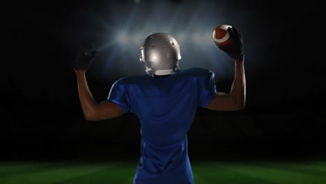 professional american football player standing in front of a sports stadium