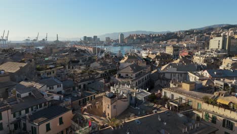 genoa's historic center with old buildings and distant port, clear day, aerial view